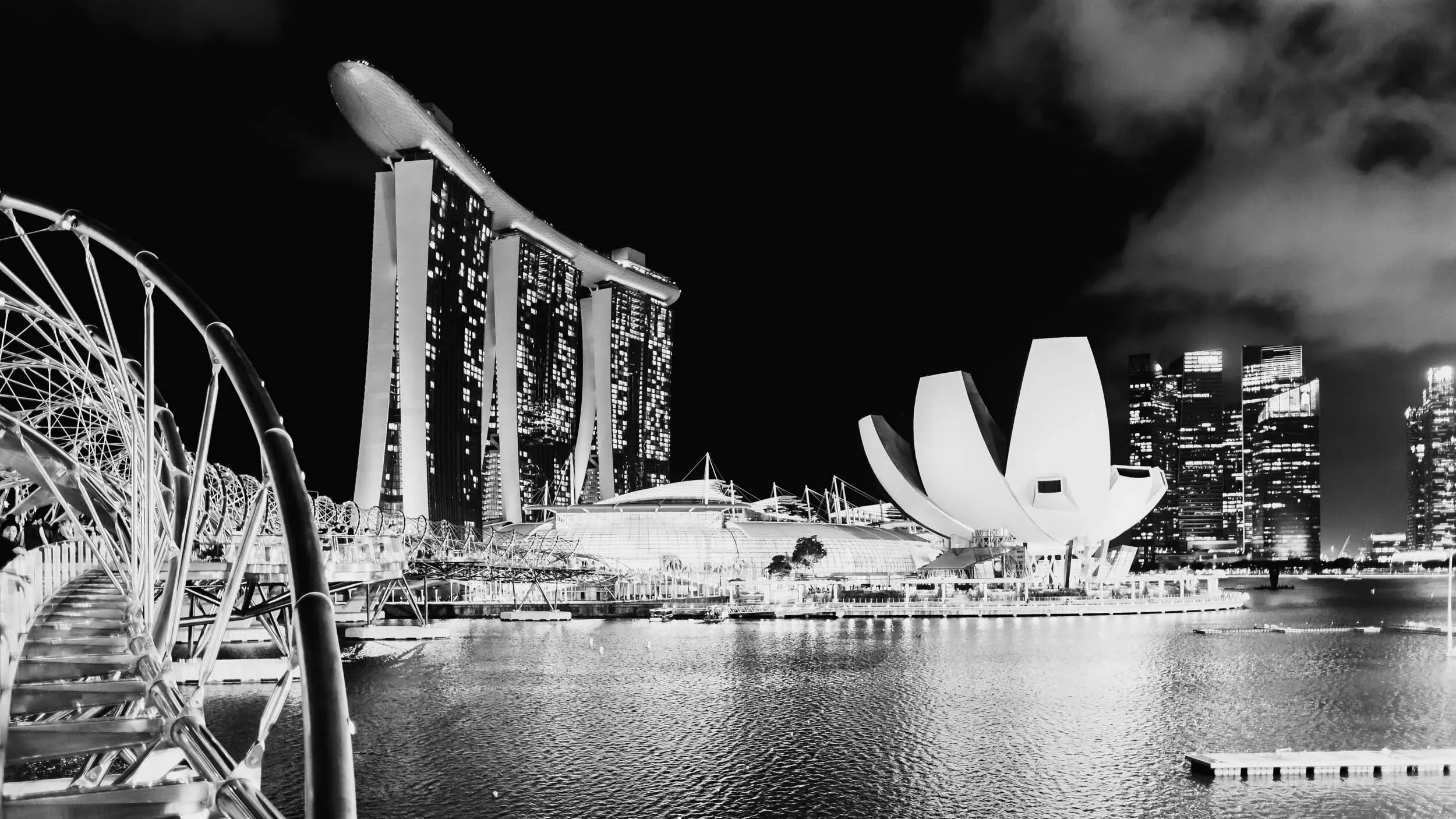 City lights and reflections across a humid night street.