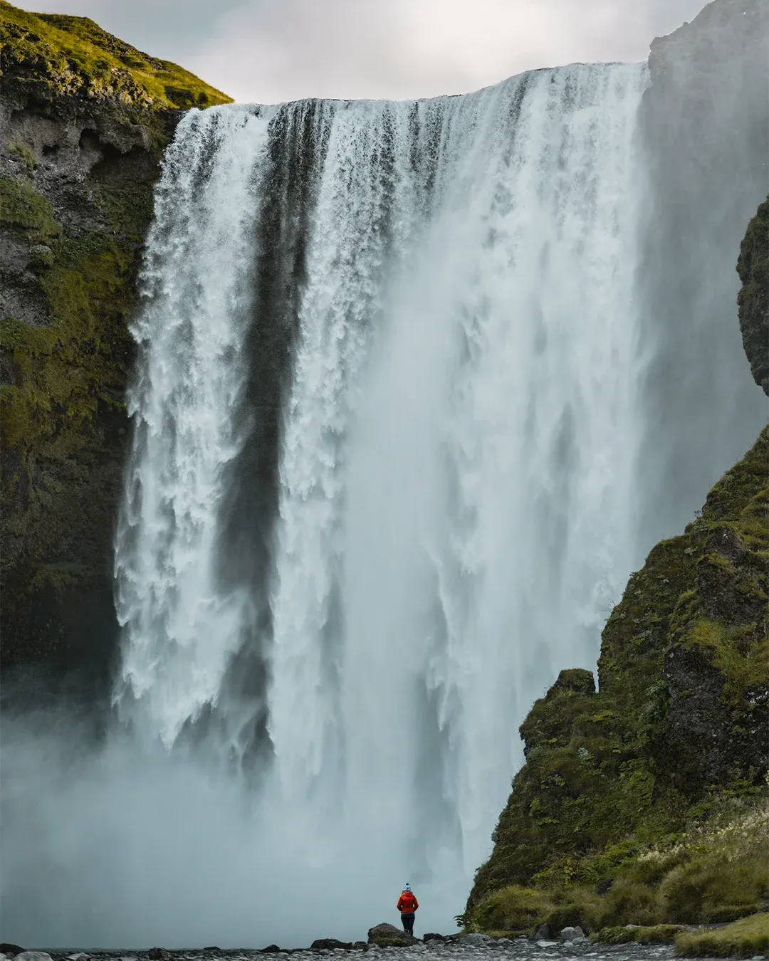 Narrow road framed by snow and low northern light.