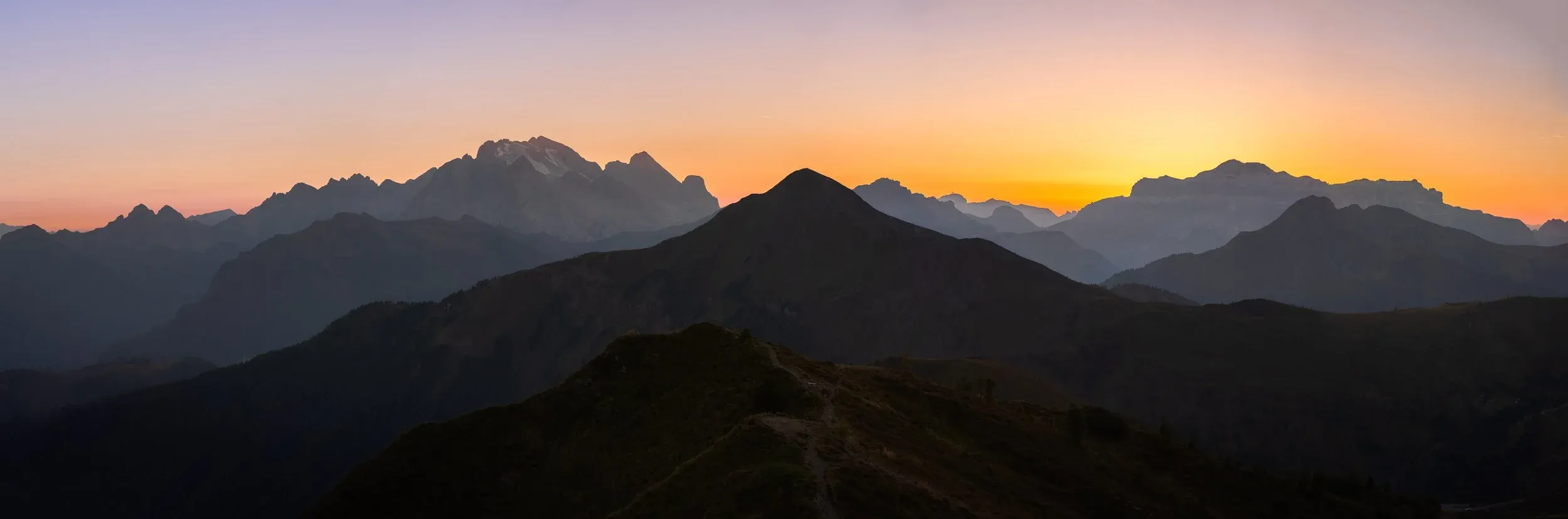 Wide panoramic view across layered desert terrain.